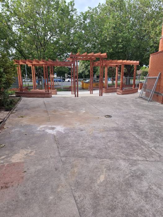 Worn and stained concrete surface in front of a church before resurfacing