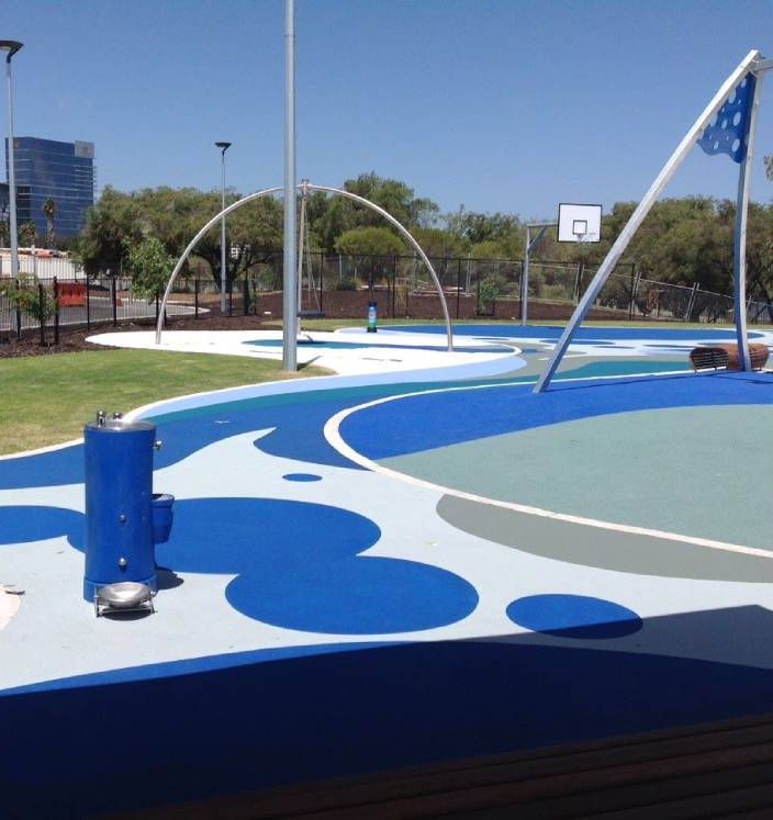 Outdoor netball court resurfaced with slip-resistant, UV-stable sports coating in bold purple, yellow, and navy design.