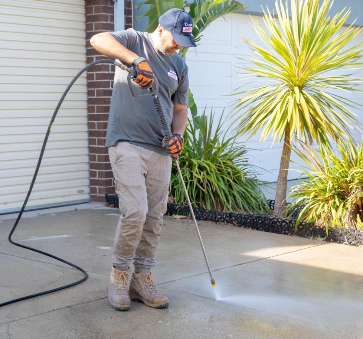 Professional driveway pressure cleaning restoring a clean, safe concrete surface