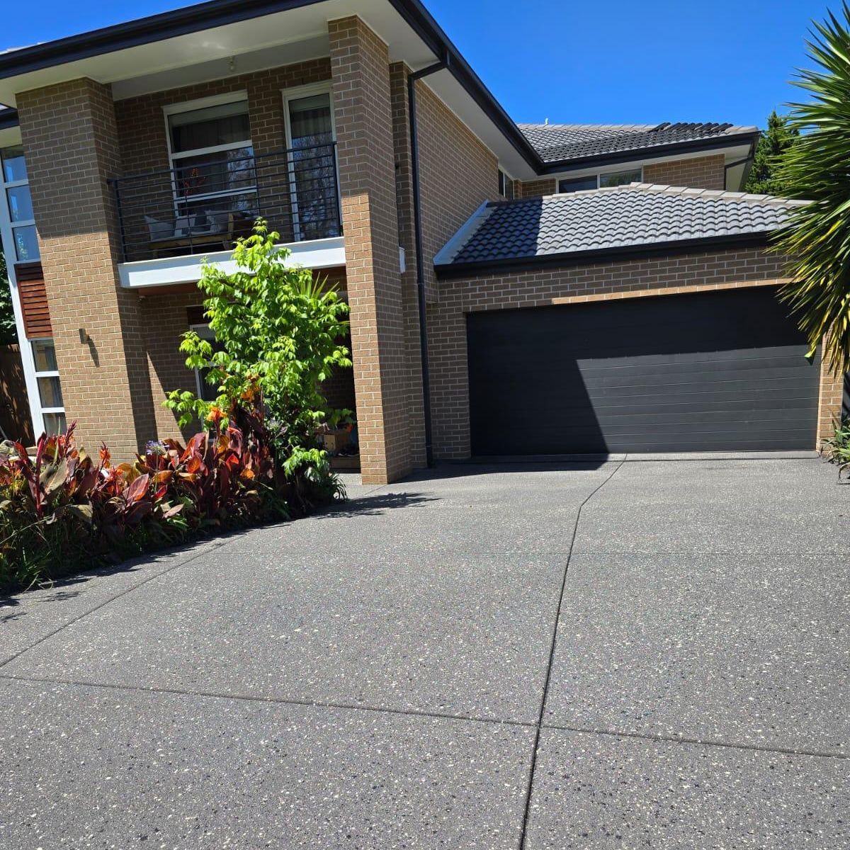 Freshly resurfaced exposed aggregate concrete driveway at a suburban Melbourne home.