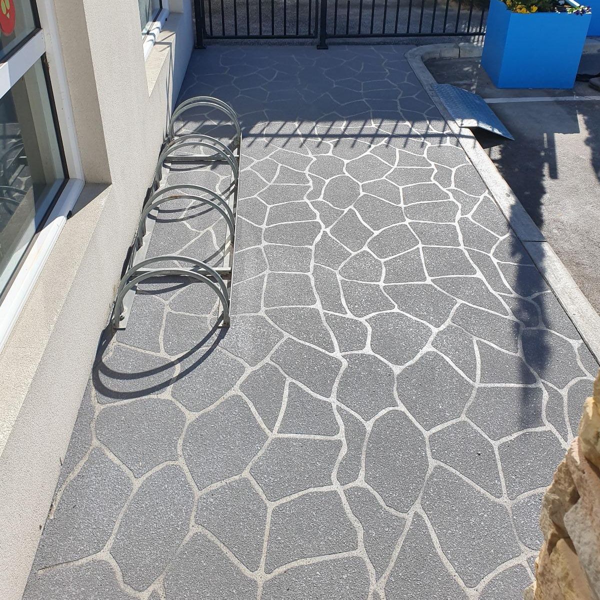Decorative concrete stencilling with a stone-like pattern at a Melbourne childcare centre.