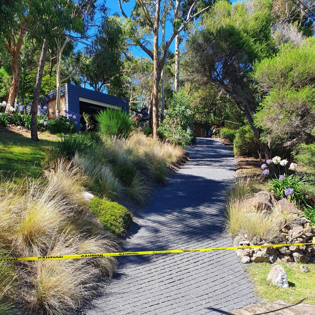 Steep driveway with permeable paving, surrounded by landscaped gardens and trees in Melbourne.