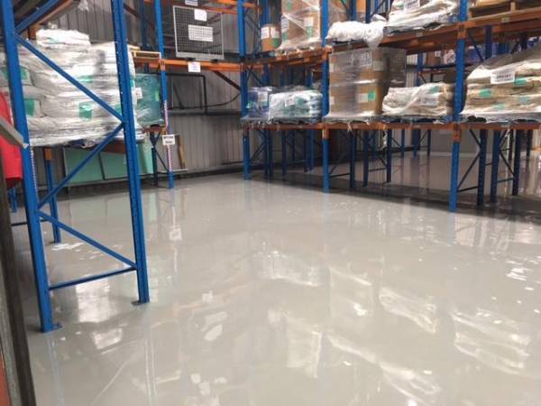 Gloss-finish resurfaced concrete floor in a factory or warehouse setting
