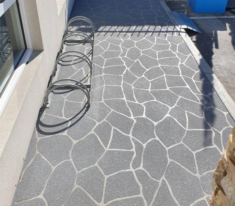 Decorative concrete stencilling with a stone-like pattern at a Melbourne childcare centre.