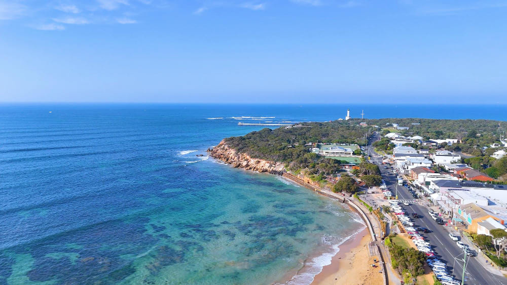 Blairgowrie, Victoria, Australia coastal view with turquoise water, sandy beach, and seaside village