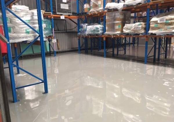 Gloss-finish resurfaced concrete floor in a factory or warehouse setting